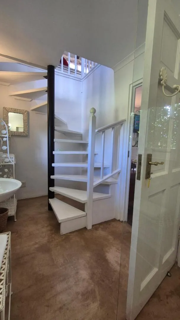 The white spiral stair up to the loft bedrooms